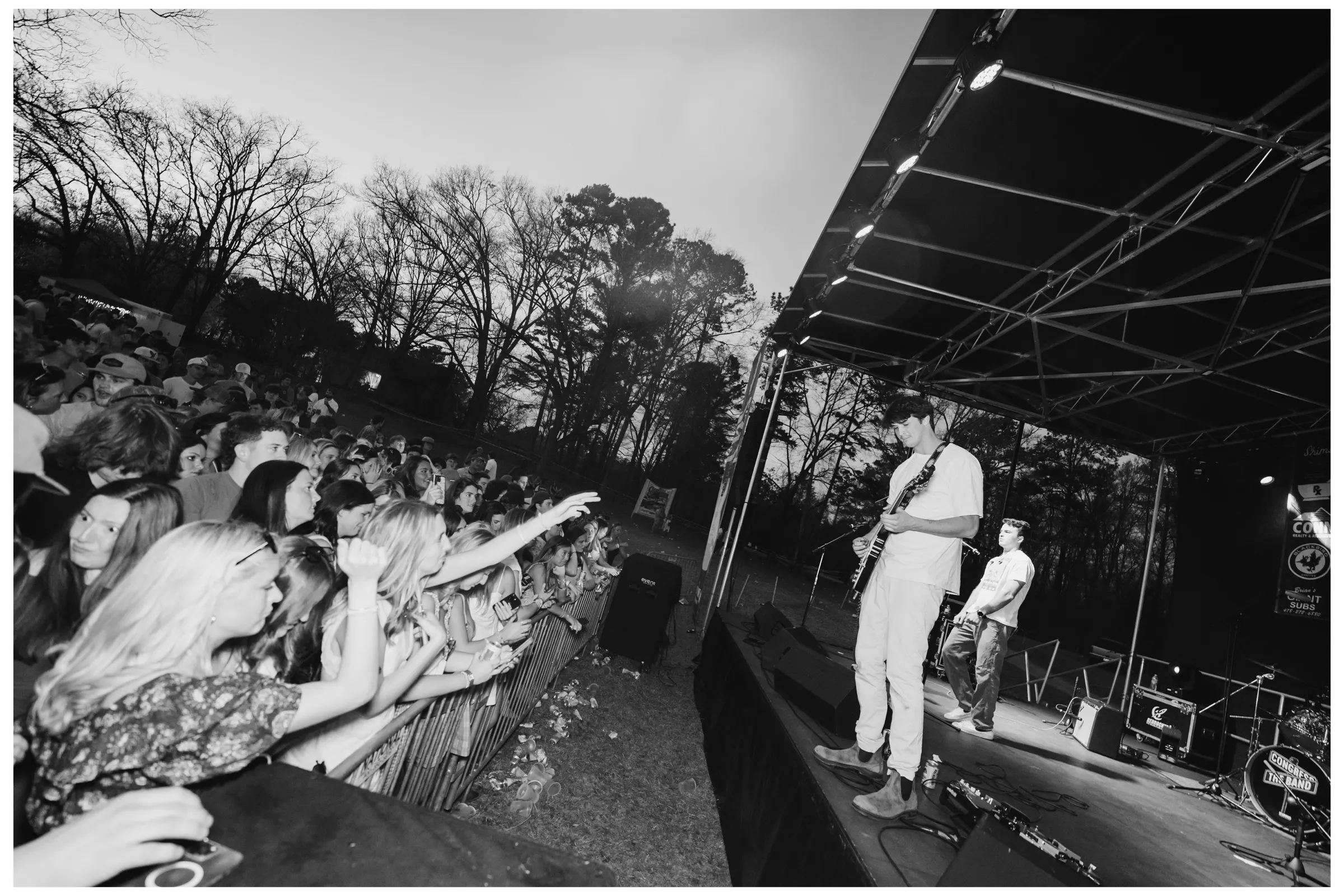 Black-and-white view from the stage wing over the crowd