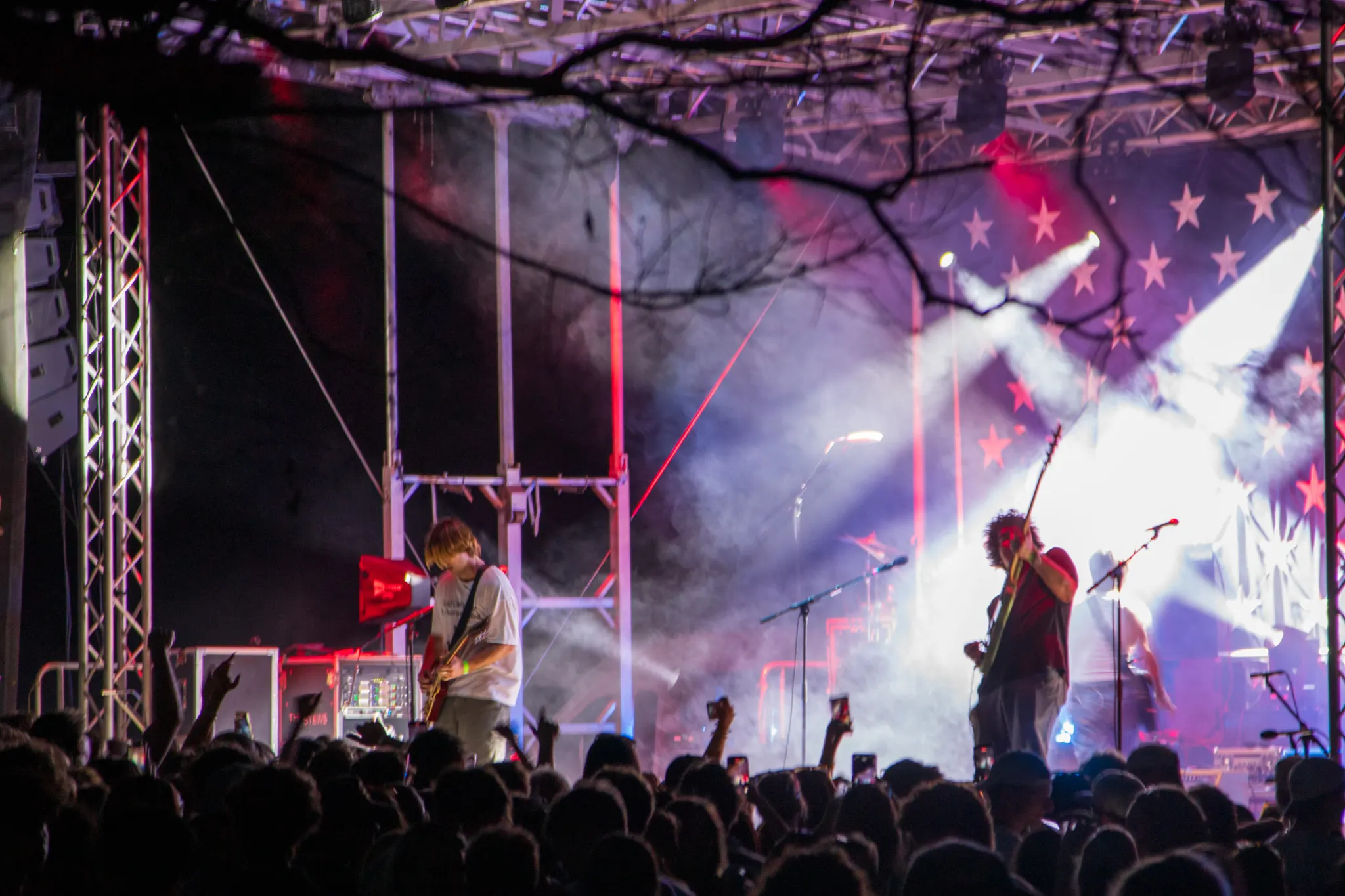 Stage lights cut through the haze during a night set